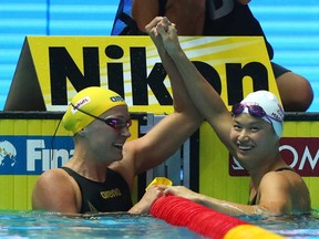 Silver medalist Sarah Sjostrom of Sweden and gold medalist Margaret MacNeil of Canada celebrate after the Women's 100m Butterfly Final on day two of the Gwangju 2019 FINA World Championships at Nambu International Aquatics Centre on July 22, 2019 in Gwangju, South Korea. (Photo by Catherine Ivill/Getty Images)