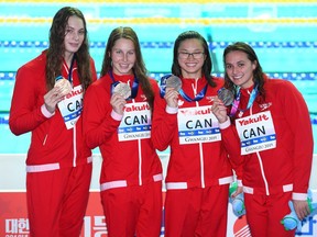 Bronze medalists Kylie Masse, Sydney Pickrem, Margaret MacNeil and Penny Oleksiak of Canada stand on the podium at the medal ceremony for the Women's 4x100m Medley Relay on day eight of the Gwangju 2019 FINA World Championships at Nambu International Aquatics Centre on July 28, 2019 in Gwangju, South Korea. (Photo by Quinn Rooney/Getty Images)