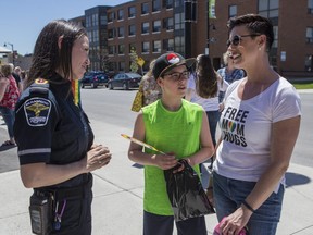 Sophie Smith-Doré (R) and her son Ethan Smith talk with County of Renfrew Paramedic Chelsea Lanos after the town of Arnprior raised its first ever Pride flag in front of its town hall for all of Pride Week. Sophie led the charge to get the town council to vote in favour of the flag. The vote, which was on May 13, was unanimous. June 7, 2019. (Errol McGihon/Postmedia Network)