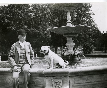 Major Thomas Beattie with pet bulldog on the fountain in Victoria Park, 1949. (London Free Press files)