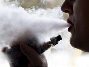 An unnamed woman blows smoke out of his mouth during a vaping session on Thursday February 21, 2019 in Brantford, Ontario. (Brian Thompson/Postmedia Network)