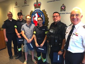 Chatham-Kent EMS general manager Donald MacLellan, left, and police Chief Gary Conn, right, recognized four first responders for their roles in the unexpected but safe home delivery of a baby girl last week. Thanked on Tuesday for their work were paramedic Jon Benoit, second from left, ambulance dispatcher Curtis LaBute, paramedic Amy Larsen and Const. Gary Oriet. (Jake Romphf, Postmedia News)
