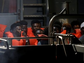 Migrants from the German rescue ship "Alan Kurdi" arrive on an Armed Forces of Malta vessel at its base in Marsamxett Harbour, Valletta, Malta July 7, 2019.  (REUTERS/Darrin Zammit Lupi/File Photo)