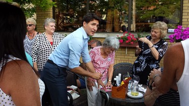Prime Minister Justin Trudeau asks for a Sharpie while visiting with people at Old South Village Pub in Wortley Village. (Dan Brown, The London Free Press)
