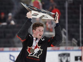 Canada's Alexis Lafreniere (11) hoists the Hlinka Gretzky Cup following the Hlinka Gretzky Cup. (File photo)