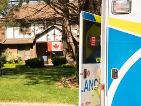 An ambulance is parked outside a home in London's Masonville area after a 28-year-old woman was found unresponsive in a backyard pool. She later died in hospital. Photo taken Sunday July 7, 2019. (Max Martin/The London Free Press)