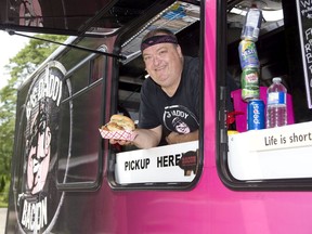 Sean Hickey of Big Daddy Bacon in London has a new food truck with which to serve culinary creations to customers. Hickey, holding his newest sandwich, the Chicken Coop, will be at Lucan BaconFest on Saturday. (Derek Ruttan/The London Free Press)