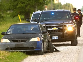 Perth County OPP called in a canine unit north of London on Thursday. An OPP officer saw this Honda Civic speeding in West Perth, and turned to make a traffic stop, when the Civic crashed into an SUV and then continued with only three wheels. The driver fled when pulled over. A woman was arrested shortly after. No one was hurt in the collision. (Mike Hensen/The London Free Press)