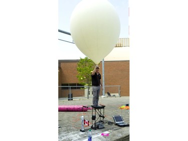 Chris Rose of SentintoSpace.com gets ready to launch an Astronaut Barbie, as well as several cameras 40 kms into space via a helium weather balloon in London, Ont. Rose was hired as part of a STEM camp at Fanshawe College where Mattel toys gave out astronaut barbies to all the participants on Friday July 5, 2019.  (Mike Hensen/The London Free Press)