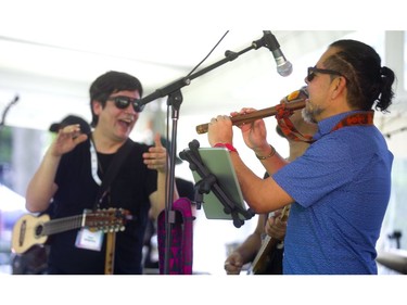 Guillermo Vaquez of the Peruvian band Lucho Quequezana plays a traditional wooden flute during the band's kickoff set Friday afternoon at Sunfest in Victoria Park in London. (Mike Hensen/The London Free Press)