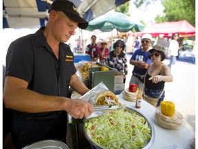 Simon Tsobanakis of Toronto was being kept busy making chicken and lamb gyros at Sunfest in Victoria Park on Friday. (Mike Hensen/The London Free Press)