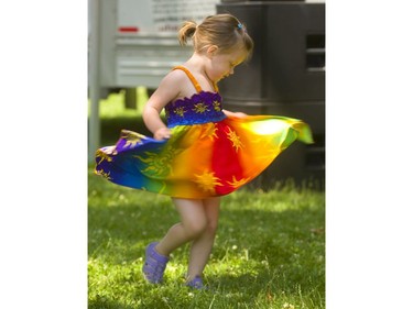 Lilah Kerkhof, 2, of London gives her colourful dress a spin as she waits for the Neema Children's Choir of Uganda to begin their set in Victoria Park on Sunday, July 7, 2019.  Mike Hensen/The London Free Press