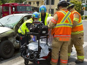 A woman was taken to hospital after being extricated from a two-vehicle collision at Waterloo and Oxford streets on Tuesday. Only one person was taken to the hospital after a pickup truck and a small sedan collided. Police are investigating the crash. (Mike Hensen/The London Free Press)