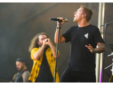 Brian Burkheiser, right, the clean vocalist for the band I Prevail, sings with Eric Vanlerberghe, who does the screamed vocals, during Start.ca's Rock the Park in London Thursday, July 11, 2019.  Mike Hensen/The London Free Press