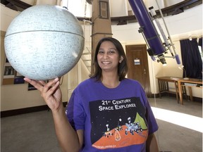 Parshati Patel holds a model of Earth's moon inside the Hume Cronyn Memorial Observatory at Western University on Monday. (Derek Ruttan/The London Free Press)