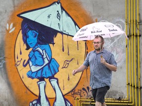 Charlie Urquhart walks along King Street on his way home after work in London. Derek Ruttan/The London Free Press)