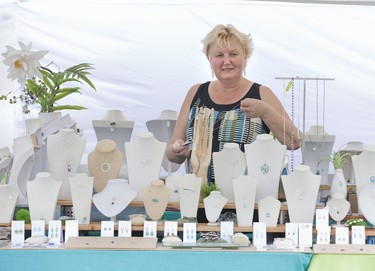 Katie Racz displays jewellery designed by herself and daughter Edina Racz in the White Lotus Design tent at the 46th Home County Music and Art Festival at Victoria Park in London, Ont. on Friday July 19, 2019. They have been selling their creations at Home County for more than ten years. Derek Ruttan/The London Free Press/Postmedia Network