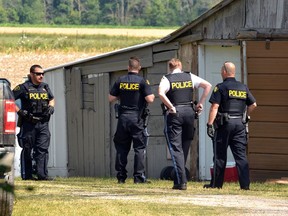 Perth County OPP officers search a farm property near Dublin, a small West Perth village, as part of a stolen property investigation. Two suspects are reportedly in custody. (GALEN SIMMONS/Beacon Herald)