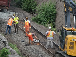 Crews cut a rail Saturday near the Sarnia opening of CN's railway tunnel under the St. Clair River. A freight train derailed early Friday in the tunnel and crews were working to return the tunnel to service.