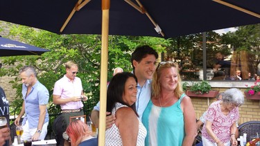 Prime Minister Justin Trudeau takes photos with people at the Old South Village Pub in Wortley Village. (Dan Brown, The London Free Press)