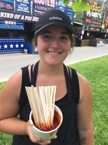 Madison Clarke offers up tastings of the Silver Bullet BBQ's sauce at London Ribfest and Craft Beer Festival Thursday. (JOE BELANGER, The London Free Press)