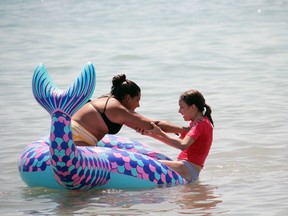 Katelyn Vieira, left, and Leah Gliddon play together at Port Stanley's Main Beach. (Laura Broadley/Times-Journal)