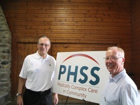Participation House Support Services' board of directors chair, Brian Orr, left, and chief executive officer, Brian Dunne, right, pose in front of the social agency's new logo and name. Sebastian Bron/The London Free Press