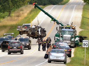 The Huron County OPP lift hoist the pickup truck involved in an accident that killed three people Monday morning out of the ditch along Brussels Line between Cardiff Road and Browntown Road in Huron East. Galen Simmons/The Beacon Herald/Postmedia Network
