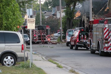 Explosion-rocked Woodman Avenue, site of Wednesday night's natural gas blast and fires in london, remained choked by fire trucks hours later Thursday morning, with about 20 firefighters still working the area. (SEBASTIAN BRON, The London Free Press)