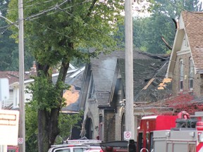 Explosion-rocked Woodman Avenue, site of Wednesday night's natural gas blast and fires in london, remained choked by fire trucks hours later Thursday morning, with about 20 firefighters still working the area. (SEBASTIAN BRON, The London Free Press)