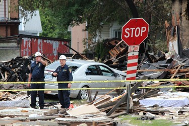 Emergency crews remained on the scene Thursday, Aug. 15, 2019, at Woodman Avenue, where a vehicle crashed into a home, causing an explosion that injured seven and damaged at least 10 homes. DALE CARRUTHERS / THE LONDON FREE PRESS