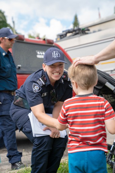 Benny MacDonald, 3, gives thanks to Shannon Byron, London fire department's public information coordinator, for her work on Wednesday night's disaster.