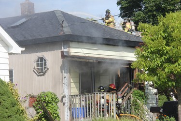 London firefighters battle a blaze on a home on Glenwood Avenue Thursday morning. One person was sent to hospital due to smoke inhalation following the fire, which caused extensive damage to the home. (JONATHAN JUHA, The London Free Press)
