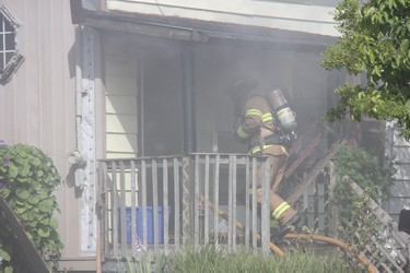London firefighters battle a blaze on a home on Glenwood Avenue Thursday morning. One person was sent to hospital due to smoke inhalation following the fire, which caused extensive damage to the home. (JONATHAN JUHA, The London Free Press)