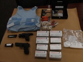 London police released this image Friday of drugs, handguns and ammunition, body armour and other items seized in a series of raids this week.  (Supplied)