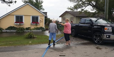 Sandra Schroeder (left) and Wendy Barnier had decided not to voluntarily evacuate from their Erie Shores Drive properties Tuesday, despite Mayor Darrin Canniff declaring a state of emergency earlier Tuesday. Flooding caused by high water levels and strong winds had prompted the declaration for the Erie Shores Drive area. TREVOR TERFLOTH/CHATHAM DAILY NEWS/POSTMEDIA NETWORK