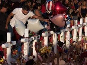 People pray and pay their respects at the makeshift memorial for victims of the shooting that killed 22 people at the Cielo Vista Mall WalMart in El Paso, Texas, on Aug. 6.