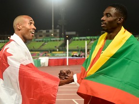 Grenada's Lindon Victor (R) greets Londoner Damian Warner at the end of the men's decathlon during the 2019 Pan-American Games in Lima on August 7, 2019. (Photo by Luis ROBAYO / AFP)