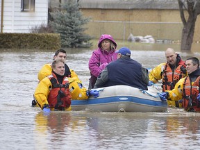 Members of the Chatham-Kent Fire & Services dive team arrived on scene at the Siskind and Pegley Court area of Chatham, Ont. on Saturday February 24, 2018 to assist some residents whose homes were flooded. Louis Pin/Chatham Daily News/Postmedia Network