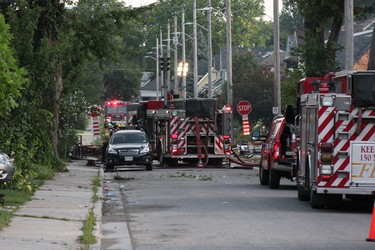 Explosion-rocked Woodman Avenue, site of Wednesday night's natural gas blast and fires in london, remained choked by fire trucks hours later Thursday morning, with about 20 firefighters still working the area.  (SEBASTIAN BRON, The London Free Press)