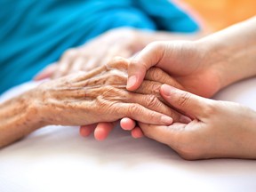 An older person holds hands with a younger person. Do older people smell different ? Studies seem to indicate so.