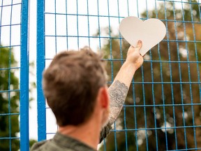 Artist David Stephen is helping to organize a neighbourhood art project on Woodman Avenue. More than 275 wooden hearts, decorated by children and residents, will be hung on the blue fence that blocks off the damaged and destroyed houses. (MAX MARTIN, The London Free Press)