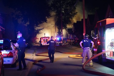 London firefighters battle a major fire on Woodman Aveune and Queens Avenue in Old East Village after a car slammed into a house. (MAX MARTIN, The London Free Press)