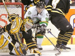 London Knights Patrick Kane pulls away from Sarnia's Jared Gomes and Christian Steingraber (8) as he tries to pounce on a rebound covered by Sting goalie Parker VanBuskirk during their OHL preseason opener on Sept. 1, 2007 at the John Labatt Centre. (Files)