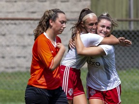 Alliance FC defender Jade Vyfhuis hangs her head as FC London's Jade Kovacevic and  Maddy Michienzi embrace after Michienzi scored her first of two in the second half of the final game of the regular season at the German Canadian Club in London. Derek Ruttan/The London Free Press)