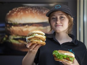 Globally Local manager Zoe Pigeon holds two of the vegan restaurant's menu items; The Famous Burger (left) and Crispy Chickun. (Derek Ruttan/The London Free Press)