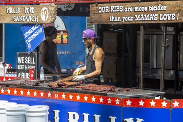 Skyler (Little Lito) Davidson of Bear Creek, Ky., grills racks of ribs at the Kentucky Smoke House stand on the first day of Rib Fest in Victoria Park in London, Thursday, Aug. 1, 2019. Derek Ruttan/The London Free Press