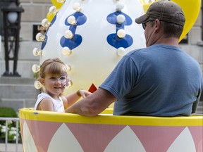 Dillan Erb (4) enjoys the Tea Cups ride with her dad Terry Erb on the first day of Rib Fest in London, Ont. on Thursday August 1, 2019. They were visiting from Clinton. Derek Ruttan/The London Free Press/Postmedia Network