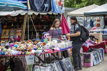 Julia Johnstone and Joshua Szalai-Muise check out one of the many vendors on the first day of Rib Fest in Victoria Park in London, Thursday Aug. 1, 2019. Derek Ruttan/The London Free Press