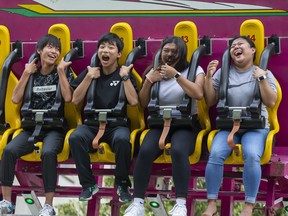 L to R Tsubasa Hagiwara and Kentarou Ohno of Tokyo, Japan have a screaming good time on the Full Tilt ride with London sisters Princess and Nichole Navalta at The London Rib Fest and Craft Beer Festival in Victoria Park in London, Ont. on Monday August 5, 2019.  They enjoyed the thrill ride so much, they got right back on for a second spin. Derek Ruttan/The London Free Press/Postmedia Network